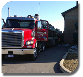 Red tractor with Schultz Inc. logo and vacuum trailer. 