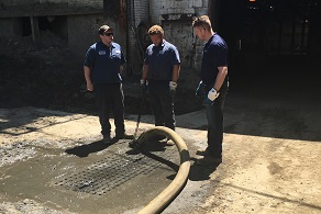 Pit Clean Team Members discussing the best way to complete a catch basin job 